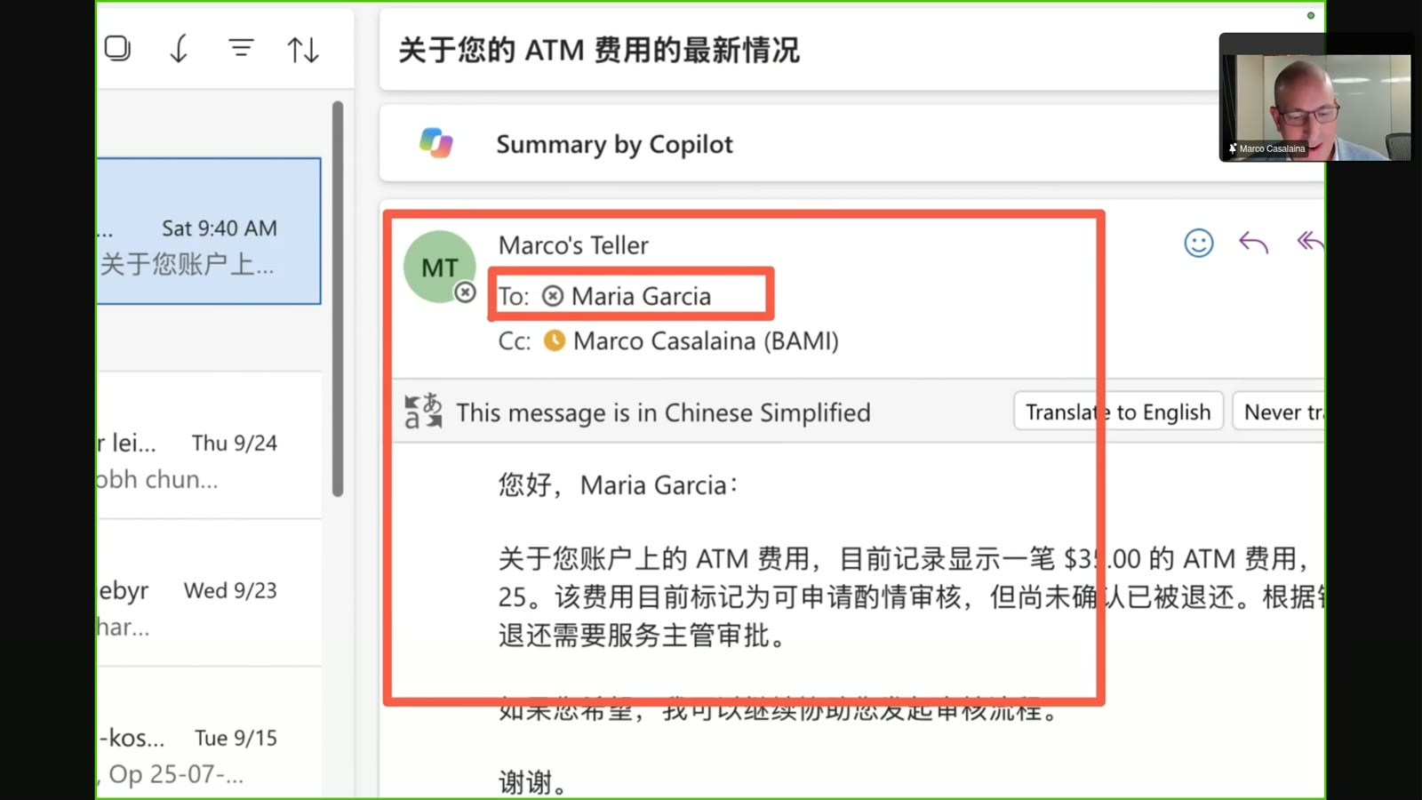 A screenshot of a video call showing a screen-shared email addressed to Maria Garcia regarding an ATM fee inquiry, with a small video inset of a man speaking in the top right corner.